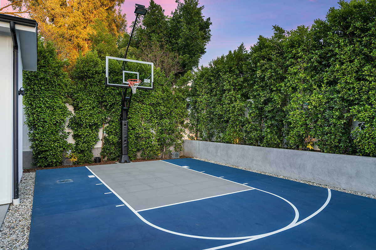 Outdoor basketball court by house